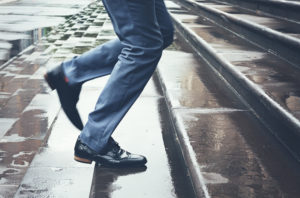 man walking on wet steps